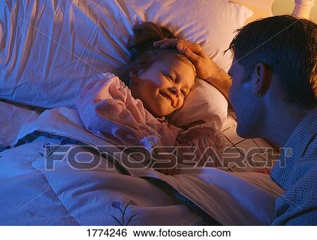 Father tucking daughter into bed View Large Photo Image Stock Photograph - Father tucking daughter into bed. Fotosearch