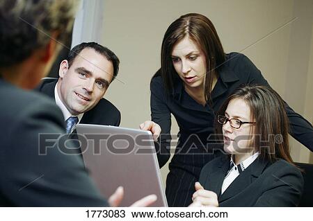 Stock Image - Group of business people in a meeting. Fotosearch
