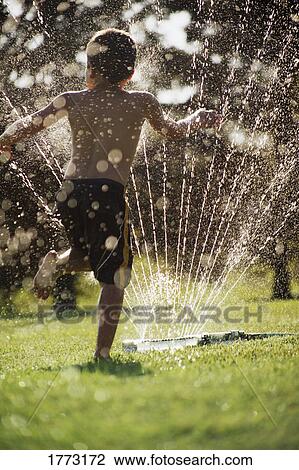 Little boy playing with garden sprinkler View Large Photo Image Stock Image - Little boy playing with garden sprinkler. Fotosearch