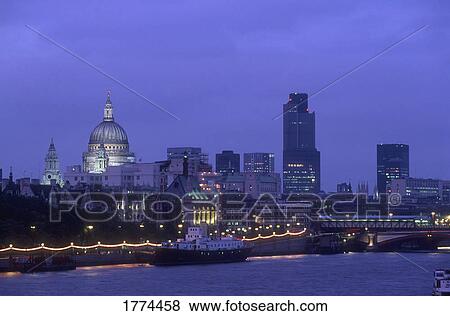 Stock Photo - London skyline and River Thames at night. Fotosearch