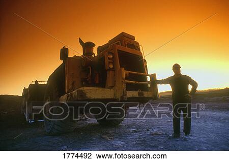 Man and machine View Large Photo Image Stock Image - Man and machine. Fotosearch