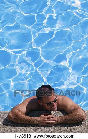 Man at side of pool View Large Photo Image Stock Photo - Man at side of pool. Fotosearch