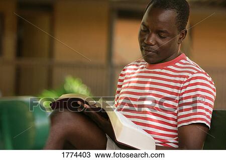Stock Image - Man reading bible. Fotosearch