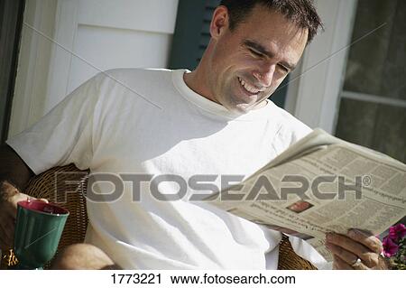 Man relaxing with newspaper View Large Photo Image Stock Image - Man relaxing with newspaper. Fotosearch