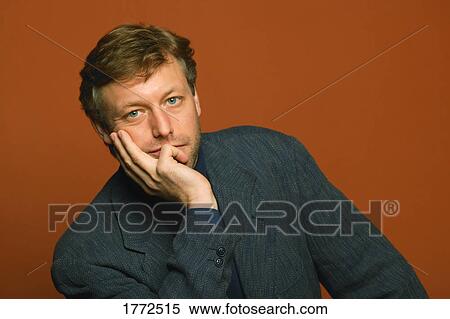 Stock Photography - Man resting chin on hand. Fotosearch