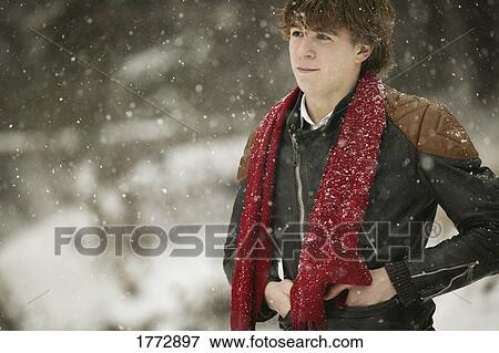 Stock Photo - Man standing while snow is falling. Fotosearch