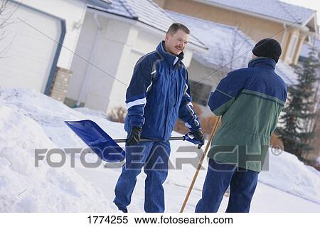 Stock Photography - Men shoveling snow. Fotosearch