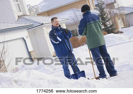 Men taking break while shoveling snow View Large Photo Image Stock Photograph - Men taking break while shoveling snow. Fotosearch