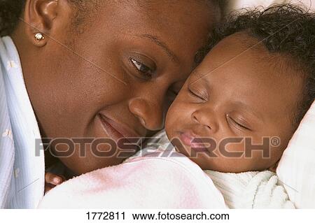 Mother looking at sleeping baby View Large Photo Image Stock Image - Mother looking at sleeping baby. Fotosearch