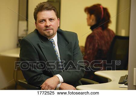 Office worker at his desk View Large Photo Image Stock Photography - Office worker at his desk. Fotosearch