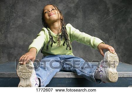 Portrait of little girl stretching View Large Photo Image Stock Photo - Portrait of little girl stretching. Fotosearch
