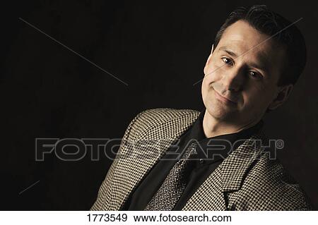 Stock Photo - Portrait of pleasant dark haired adult man. Fotosearch