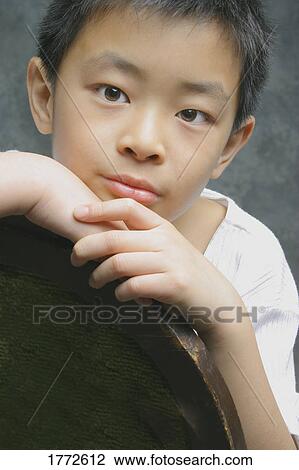 Stock Image - Portrait of young Asian boy. Fotosearch