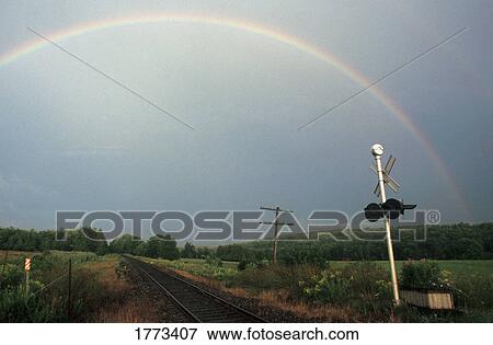 Stock Photo - Rainbow over a railway track. Fotosearch