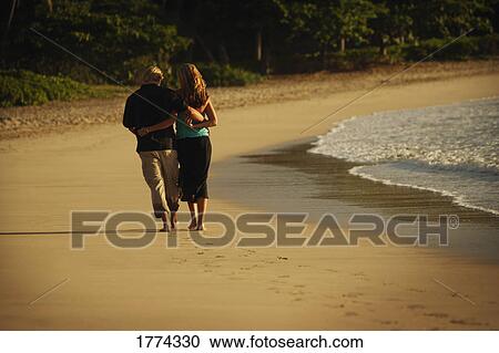 Romantic stroll along the beach View Large Photo Image Stock Image - Romantic stroll along the beach. Fotosearch
