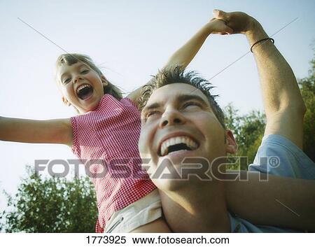 Sitting on daddy's shoulders View Large Photo Image Stock Photography - Sitting on daddy's shoulders. Fotosearch