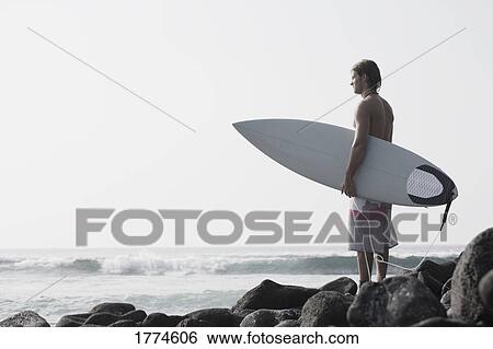 Surfer looking out to sea View Large Photo Image Stock Photograph - Surfer looking out to sea. Fotosearch