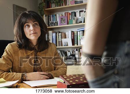 Teacher listens to student View Large Photo Image Stock Photo - Teacher listens to student. Fotosearch