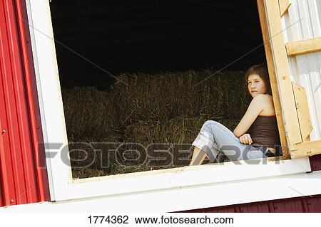 Teen looking out hay loft window View Large Photo Image Stock Image - Teen looking out hay loft window. Fotosearch