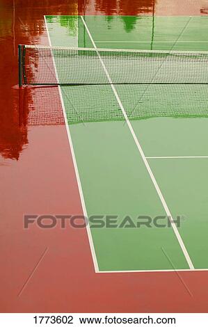 Stock Image - Tennis court flooded. Fotosearch