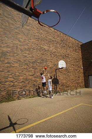 Two young basketball players View Large Photo Image Stock Photo - Two young basketball players. Fotosearch