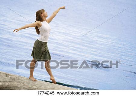 Woman balancing on log View Large Photo Image Stock Photography - Woman balancing on log. Fotosearch