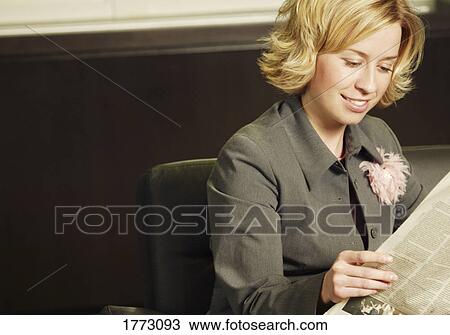 Woman reading a newspaper View Large Photo Image Stock Image - Woman reading a newspaper. Fotosearch