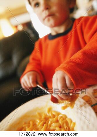 Young boy eating View Large Photo Image Stock Image - Young boy eating. Fotosearch