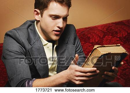 Young man holding old book View Large Photo Image Stock Image - Young man holding old book. Fotosearch