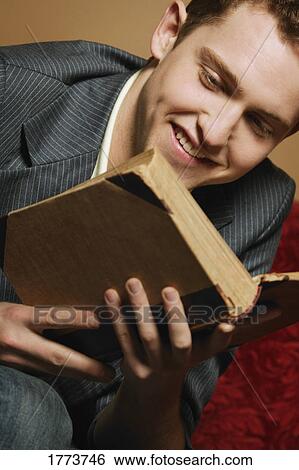Stock Photograph - Young man reading. Fotosearch
