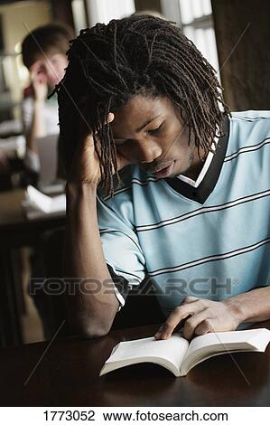 Stock Image - Young man studying. Fotosearch