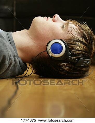 Young man with headphones View Large Photo Image Stock Photography - Young man with headphones. Fotosearch