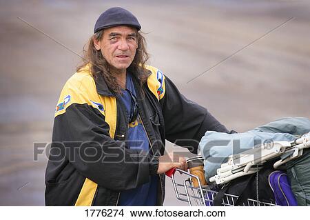 A homeless with his life in a shopping basket View Large Photo Image Picture - A homeless with his life in a shopping basket. Fotosearch