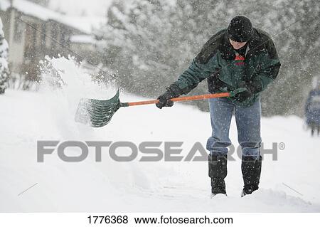 A man clearing snow View Large Photo Image Stock Photo - A man clearing snow. Fotosearch
