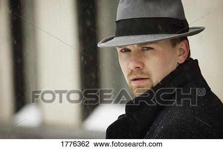 Stock Image - A man wearing a gray hat. Fotosearch