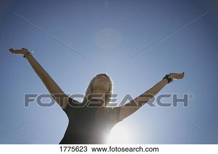 A woman raises her arms in praise View Large Photo Image Stock Image - A woman raises her arms in praise. Fotosearch