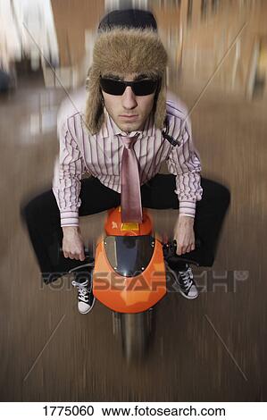 Stock Image - Big man on tiny bike. Fotosearch