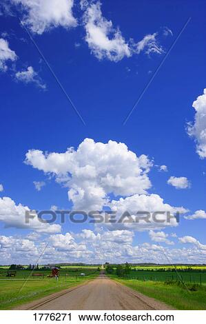 Stock Image - Blue skies and green countryside. Fotosearch