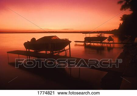 Stock Image - Boats at sunset. Fotosearch
