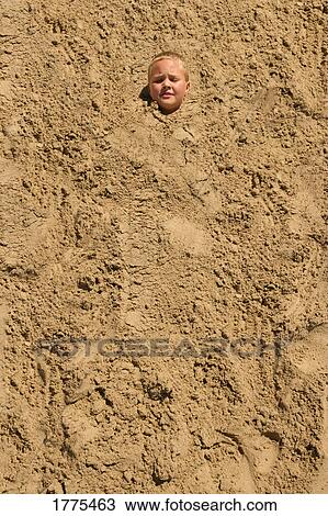 Boy covered in sand at beach View Large Photo Image Stock Image - Boy covered in sand at beach. Fotosearch