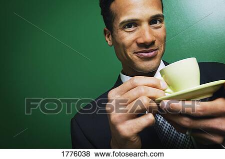 Stock Photo - Businessman having a coffee. Fotosearch