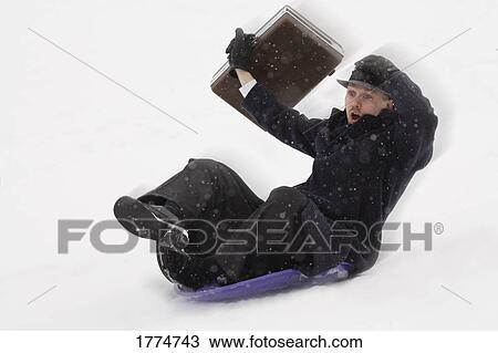 Businessman sledding in the snow View Large Photo Image Stock Image - Businessman sledding in the snow. Fotosearch