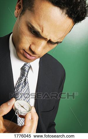 Businessman using a compass View Large Photo Image Stock Photography - Businessman using a compass. Fotosearch