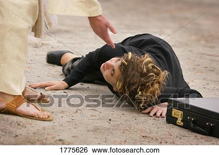 Stock Photograph - Businesswoman on ground, hand reaching down to help. Fotosearch