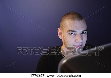 Stock Photo - Casual man working overtime. Fotosearch