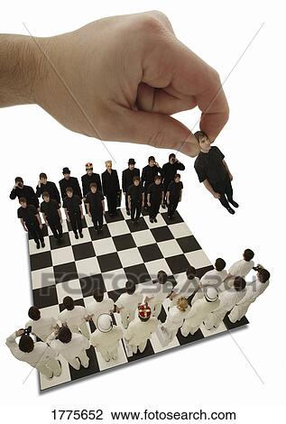 Stock Image - Chess being played with little people. Fotosearch