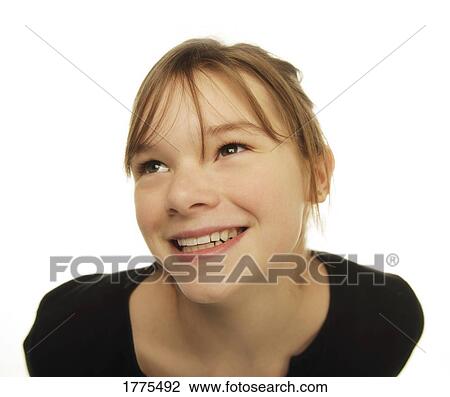 Stock Image - Close up portrait of smiling young girl. Fotosearch