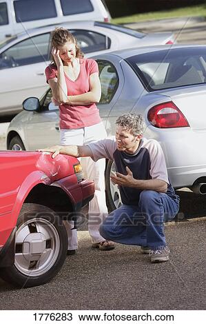 Couple return to find their car damaged View Large Photo Image Stock Image - Couple return to find their car damaged. Fotosearch