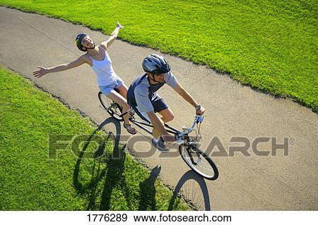 Couple riding a tandem View Large Photo Image Stock Photo - Couple riding a tandem. Fotosearch