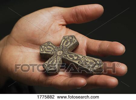 Stock Image - Cross in palm of hand. Fotosearch